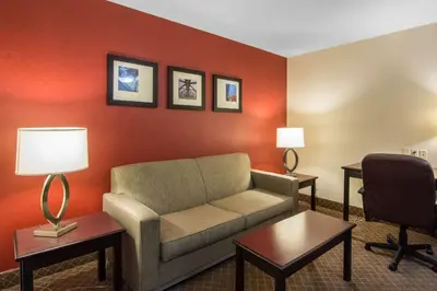 a living room with a couch and a desk at Comfort Inn & Suites Airport South in Calgary