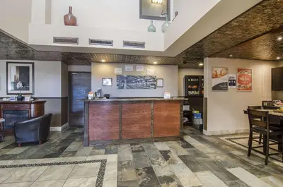 a bar in a restaurant with a table and chairs at Econo Lodge Lloydminster in Lloydminster