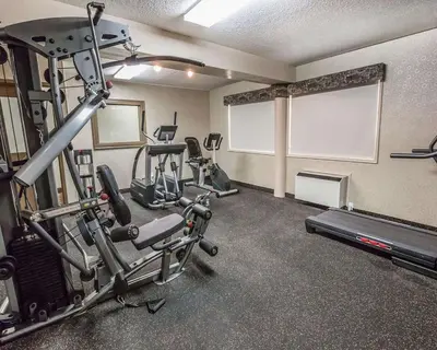 a gym with several treadmills and a treadmill at Quality Inn & Conference Centre in Red Deer