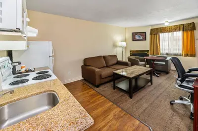 a hotel room with a kitchen and a living room at Econo Lodge Inn & Suites High Level in High Level