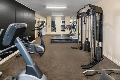a gym with treadmills and elliptical machines at Econo Lodge Inn & Suites High Level in High Level