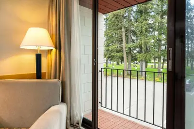 a room with a window with a view of a porch at Prestige Riverside Lodge Quesnel in Quesnel