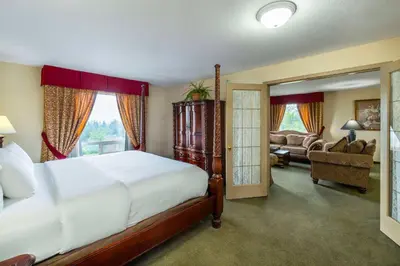 a bedroom with a bed and a living room at Comfort Inn & Suites in Salmon Arm