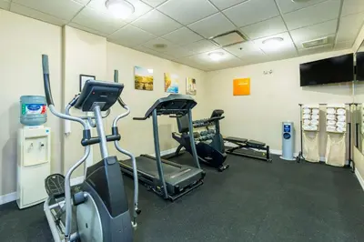 a gym with two tread machines and a flat screen tv at Comfort Inn & Suites in Salmon Arm