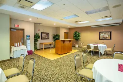 a conference room with tables and chairs and a podium at Comfort Inn & Suites in Salmon Arm
