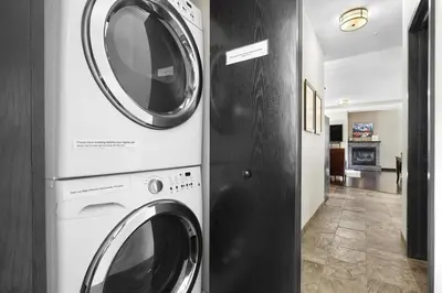 two washing machines are next to each other in a room at Sundance Suite - Beautiful Condo With Open Pool And Hot Tub in Canmore