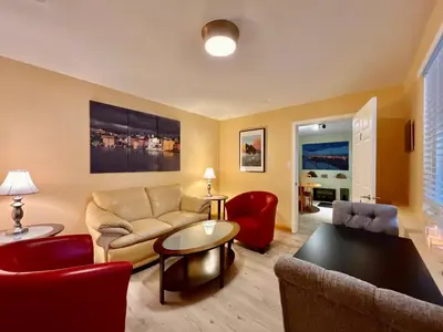 a living room with a couch and a table at Frigon Suite -Waterfront in Port Alice