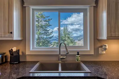 a kitchen sink with a window above it at Semi-Lakefront Luxury Retreat In Blind Bay, Bc Cottage in Blind Bay