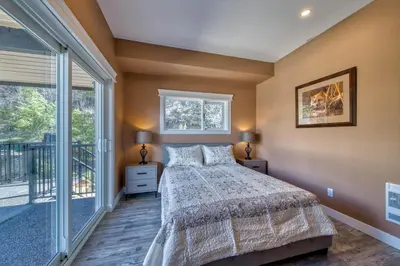 a bedroom with a bed and a large window at Semi-Lakefront Luxury Retreat In Blind Bay, Bc Cottage in Blind Bay