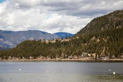 a large body of water with mountains in the background at Semi-Lakefront Luxury Retreat In Blind Bay, Bc Cottage in Blind Bay