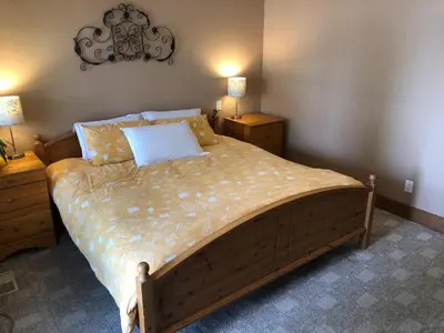 a bedroom with a large bed with two night stands at Lakefront Townhouse Family Complex, Popular Wine Country and the Best Golfing in Osoyoos