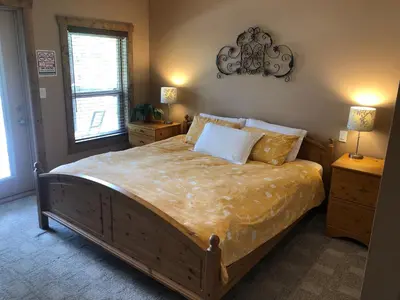 a bedroom with a large bed with two night stands at Lakefront Townhouse Family Complex, Popular Wine Country and the Best Golfing in Osoyoos
