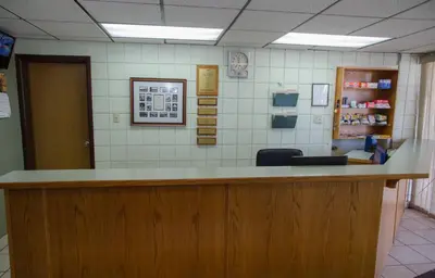 a lobby of a pharmacy with a reception counter at Plains Motel in Brooks