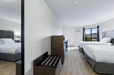 a hotel room with two beds and a window at The Vista Inn in Kamloops