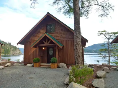 a cabin on the shore of a lake at Brown's Bay Resort in Campbell River