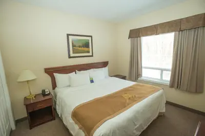 a hotel room with a bed and a window at Lakeview Inns & Suites - Chetwynd in Chetwynd