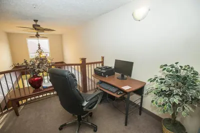 an office with a desk and a computer on a balcony at Lakeview Inns & Suites - Chetwynd in Chetwynd