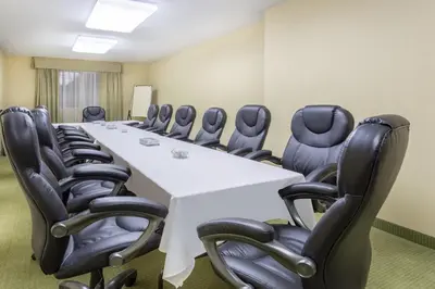 a conference room with a long table and chairs at Ramada by Wyndham Williams Lake in Williams Lake