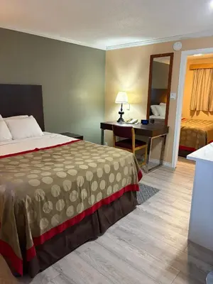 a hotel room with a bed and a desk at Grand Forks Inn in Grand Forks