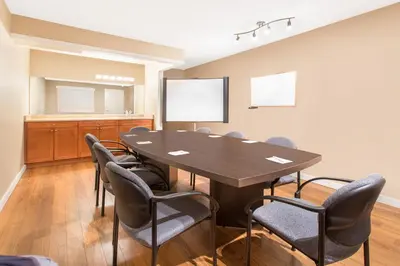 a conference room with a table and chairs at Grand Forks Inn in Grand Forks