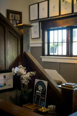a room with a desk with flowers on it at The Ivy on Parker Guest House in Vancouver