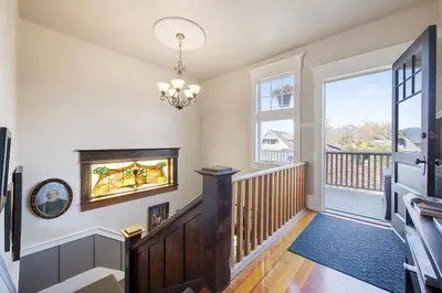 a room with a staircase with a large window at The Ivy on Parker Guest House in Vancouver