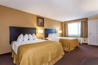 a hotel room with two beds and a window at Quality Inn Merritt in Merritt