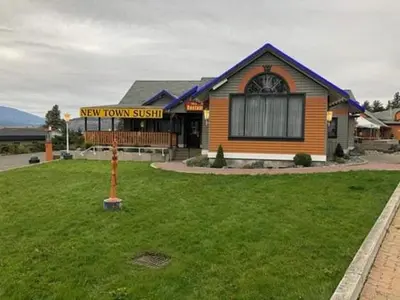 a new town sign in front of a building at Quality Inn Merritt in Merritt