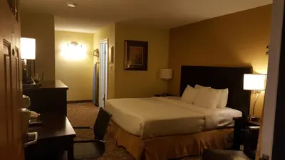 a hotel room with a bed and a desk at Quality Inn Merritt in Merritt