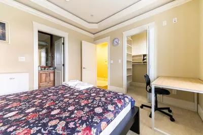 a bedroom with a bed and a desk and a desk at Mike's Luxury House in Vancouver