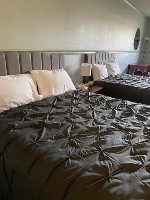 a bedroom with a large bed and a bedskirts at Elite Hotel -Downtown Center- 