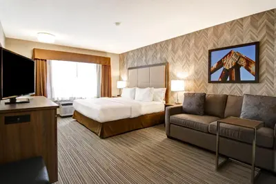 a hotel room with a bed and a couch at Canalta Brooks in Brooks