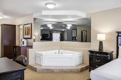 a large bathroom with a white tub in a room at Ramada by Wyndham Lac La Biche in Lac La Biche