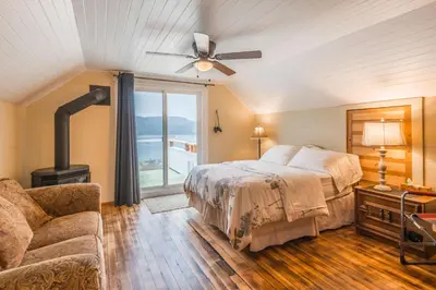 a bedroom with a bed and a ceiling fan at Outdoor Lovers in Port Alberni