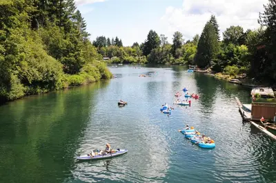 a group of people in canoes on a river at Valley View in Lake Cowichan