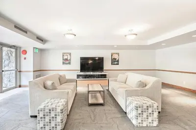 a living room with two couches and a tv at The Best ski-in/ski-out at The Aspens in Whistler