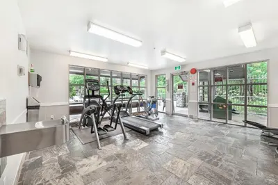 a gym with treadmills and ellipticals in a building at The Best ski-in/ski-out at The Aspens in Whistler