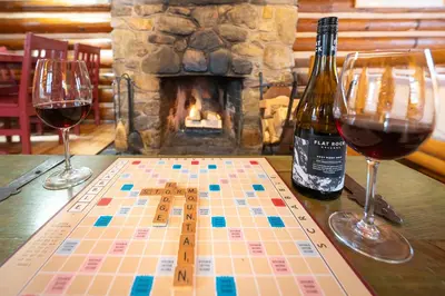 a chess board and two wine glasses on a table at Storm Mountain Lodge & Cabins in Banff