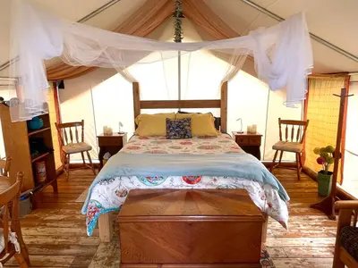 a bedroom with a bed in a tent at So Damn Lucky Glamping in Ucluelet