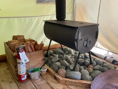 a grill sitting on top of a pile of rocks at So Damn Lucky Glamping in Ucluelet