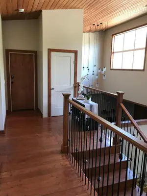 an empty room with a staircase and a door at Wesbert Winery & Guest Suites in Penticton