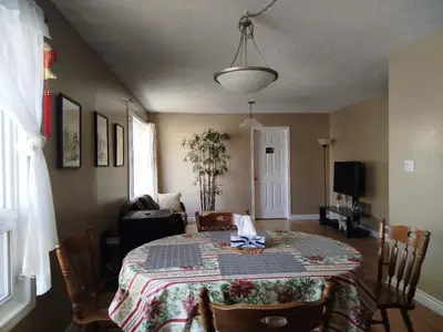 a dining room with a table with a bow on it at Jenny Guest House in Yellowknife