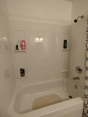 a white bath tub in a bathroom at Jenny Guest House in Yellowknife