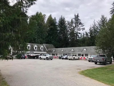 a group of cars parked in front of a building at Pines Motel in Sicamous