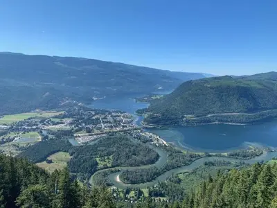 an aerial view of a river in a valley at Pines Motel in Sicamous