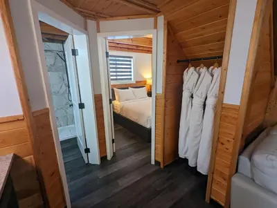 a bedroom with a bed and a bed and a mirror at Halcyon Hot Springs Resort in Halcyon Hot Springs