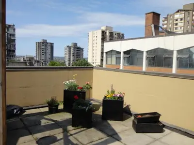 a balcony with three potted plants on a building at HI Vancouver Downtown - Hostel in Vancouver