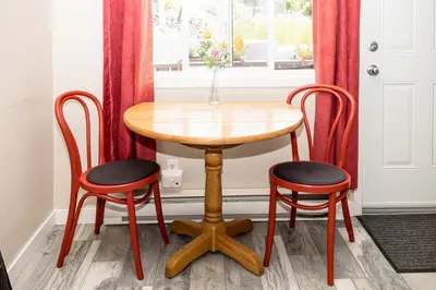 a wooden table with two chairs and a window at Crescent Motel in Radium Hot Springs