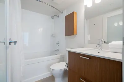 a bathroom with a toilet and a sink and a tub at Level Vancouver Yaletown - Seymour in Vancouver