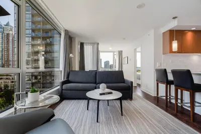 a living room with a couch and a table at Level Vancouver Yaletown - Seymour in Vancouver